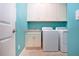 Bright laundry room with white cabinets and granite countertop at 1847 Pacific Dunes Dr, Sun City Center, FL 33573