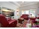 Relaxing living room featuring a large TV and comfortable seating at 1847 Pacific Dunes Dr, Sun City Center, FL 33573