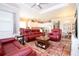 Living room with red leather furniture and a view of the kitchen at 1847 Pacific Dunes Dr, Sun City Center, FL 33573