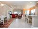 Open living area with red reclining sofas, dining area, and kitchen at 1847 Pacific Dunes Dr, Sun City Center, FL 33573