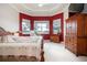 Main bedroom with large windows, red accent wall, and ample space at 1847 Pacific Dunes Dr, Sun City Center, FL 33573
