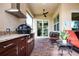 Screened patio with outdoor kitchen and seating area at 1847 Pacific Dunes Dr, Sun City Center, FL 33573