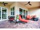 Relaxing patio with brick pavers, outdoor seating, and lush greenery at 1847 Pacific Dunes Dr, Sun City Center, FL 33573