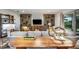 Inviting living room with comfortable seating, a unique accent wall, and natural light at 18472 Vista Park Ter, Venice, FL 34293