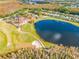 Aerial view showing clubhouse near lake and golf course at 18801 Chaville Rd, Lutz, FL 33558