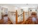 Upstairs hallway with hardwood floors and access to bedrooms at 18801 Chaville Rd, Lutz, FL 33558