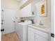 Bright laundry room with washer, dryer, and utility sink at 18801 Chaville Rd, Lutz, FL 33558