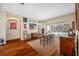 Bright living room with hardwood floors, leather sofas, and a view of the pool at 18801 Chaville Rd, Lutz, FL 33558