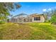 Backyard oasis with a screened-in pool and lush green grass at 18801 Chaville Rd, Lutz, FL 33558