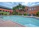 Community pool with brick patio and seating at 1910 E Palm Ave # 10303, Tampa, FL 33605
