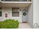 Condo entrance with gray door and wreath at 1945 Pelican Landing Blvd # 616, Clearwater, FL 33762