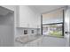 Kitchen with white cabinets and granite countertops at 1945 Pelican Landing Blvd # 616, Clearwater, FL 33762