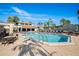 Community pool with lounge chairs and a grilling area at 1945 Pelican Landing Blvd # 616, Clearwater, FL 33762