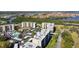 An aerial view of the community, including the water, condo buildings, and pool at 2700 Cove Cay Dr # 2F, Clearwater, FL 33760
