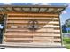 Close-up of a rustic wooden sign for 'AJs Dockside Bar & Grill', featuring an anchor and the establishment date at 2700 Cove Cay Dr # 2F, Clearwater, FL 33760