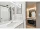 Bright bathroom featuring a vanity with mirror and a door leading to a shower at 2700 Cove Cay Dr # 2F, Clearwater, FL 33760
