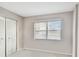 Well-lit bedroom features neutral walls, carpet, and a window with blinds at 2700 Cove Cay Dr # 2F, Clearwater, FL 33760