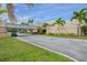 Entrance to the Cove Cay Golf Club with signage, landscaping and palms at 2700 Cove Cay Dr # 2F, Clearwater, FL 33760