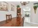 Open dining room with seating for four under a decorative chandelier, with views to the kitchen at 2700 Cove Cay Dr # 2F, Clearwater, FL 33760
