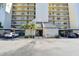 A charming condo building with covered parking spaces, a well-maintained front entrance, and lush landscaping at 2700 Cove Cay Dr # 2F, Clearwater, FL 33760