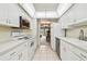 Bright kitchen featuring white cabinetry, modern appliances, and an open view to the dining area at 2700 Cove Cay Dr # 2F, Clearwater, FL 33760