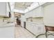 Bright kitchen featuring white cabinetry, modern appliances, and an open view to the dining area at 2700 Cove Cay Dr # 2F, Clearwater, FL 33760