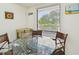 Close up of kitchen nook featuring a glass table, seating for four, and a great view outside at 2700 Cove Cay Dr # 2F, Clearwater, FL 33760