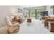 Inviting living room with plush carpeting and lots of natural light at 2700 Cove Cay Dr # 2F, Clearwater, FL 33760