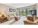 Comfortable living room features a large sliding glass door leading to a private balcony at 2700 Cove Cay Dr # 2F, Clearwater, FL 33760