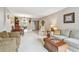 Spacious living room features comfortable seating and dining table with view to Kitchen at 2700 Cove Cay Dr # 2F, Clearwater, FL 33760