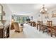 Cozy living room featuring neutral-toned walls, plush carpet, and sliding glass doors to the outside at 2700 Cove Cay Dr # 2F, Clearwater, FL 33760