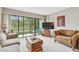 Bright and airy living room with access to balcony through large sliding glass doors at 2700 Cove Cay Dr # 2F, Clearwater, FL 33760