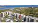 Scenic aerial view of condo complex with lush landscaping and waterfront views and covered parking at 2700 Cove Cay Dr # 2F, Clearwater, FL 33760