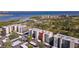 Scenic aerial view of condo complex with lush landscaping and waterfront views and covered parking at 2700 Cove Cay Dr # 2F, Clearwater, FL 33760