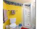 Yellow bathroom with a shower, toilet, and ocean-themed border at 301 Hope St, Tarpon Springs, FL 34689