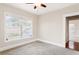 Empty bedroom with neutral walls, carpeted floor, and window at 323 W Hanna Ave, Tampa, FL 33604