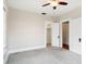 Empty bedroom with carpet, ceiling fan, open closet, and two doorways at 323 W Hanna Ave, Tampa, FL 33604
