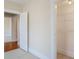 Empty bedroom with neutral walls, carpeted floor, open door, and closet at 323 W Hanna Ave, Tampa, FL 33604