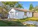White detached garage with a single garage door and a window at 323 W Hanna Ave, Tampa, FL 33604