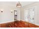 Dining room with hardwood floors, French doors, and access to the kitchen at 323 W Hanna Ave, Tampa, FL 33604