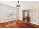 Dining room with hardwood floors, a large window, and French doors at 323 W Hanna Ave, Tampa, FL 33604