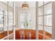 Dining room with hardwood floors, French doors, and a decorative light fixture at 323 W Hanna Ave, Tampa, FL 33604