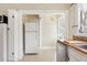 Kitchen features white appliances, tile floor, and access to a back door at 323 W Hanna Ave, Tampa, FL 33604