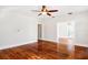 Living room with hardwood floors, ceiling fan, and doorway to another room at 323 W Hanna Ave, Tampa, FL 33604