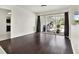 Living room featuring dark wood-look floors and sliding glass doors leading to the backyard at 3320 Lake Padgett Dr, Land O Lakes, FL 34639