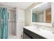 Bathroom with a shower/tub combo, vanity with white countertop and a large mirror at 39045 Sabal Ave, Zephyrhills, FL 33542