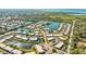 Aerial view of community with lake, pool, and lush landscaping at 4235 Stratford Dr, New Port Richey, FL 34652