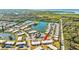Aerial view showing condo location in community with pool and lake at 4235 Stratford Dr, New Port Richey, FL 34652
