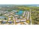 Aerial view of community with lake, pool, and lush landscaping at 4235 Stratford Dr, New Port Richey, FL 34652