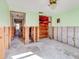 Unfinished bedroom showing exposed walls and flooring during remodel at 4235 Stratford Dr, New Port Richey, FL 34652